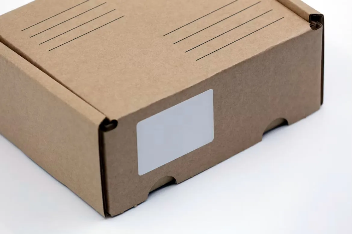 A cardboard shipping box with blank address lines and an unfilled label.