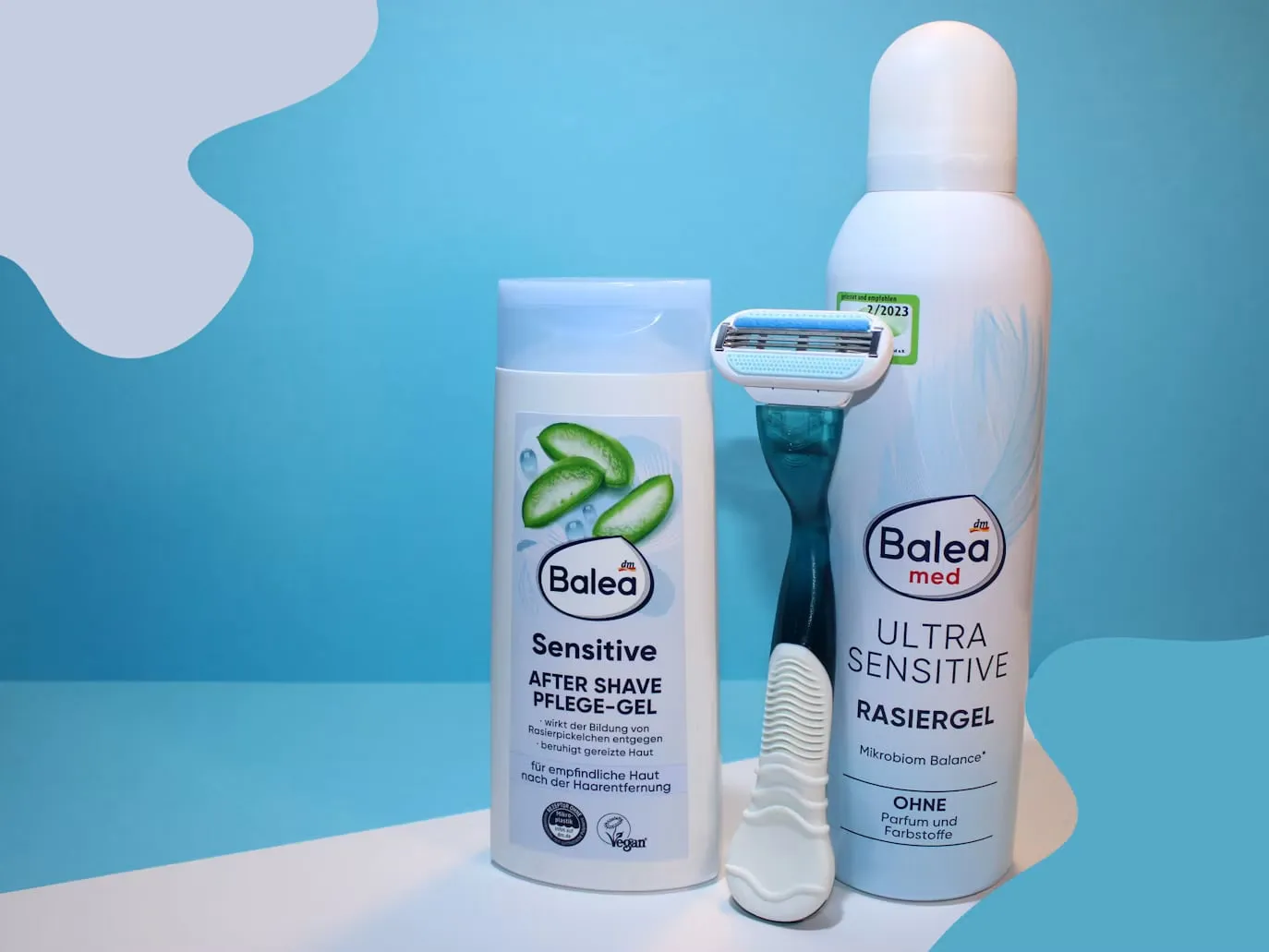 A razor, shaving gel and aftershave arranged as complementary grooming products.