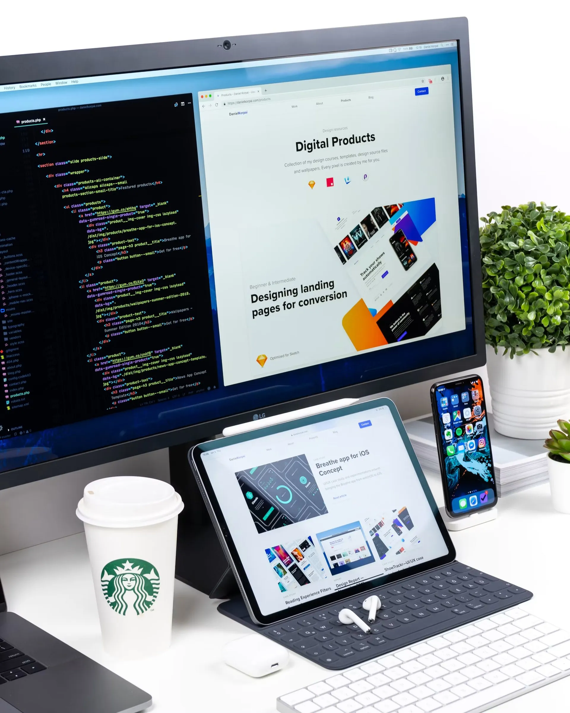 A desktop design workspace showing website code and page layouts across a monitor and tablet.